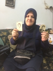 Hussein's Sister, Imane, Holding The Photo Of Hussein and Ahmad; Her Two Missing Brothers