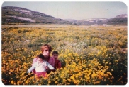 Kariman with her children at a field filled with rflowers